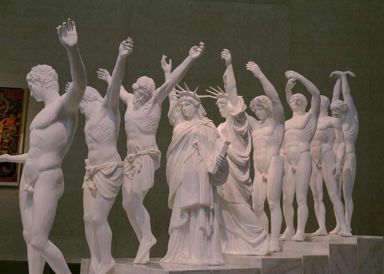Intricate white statues displayed at a Canberra museum exhibition.